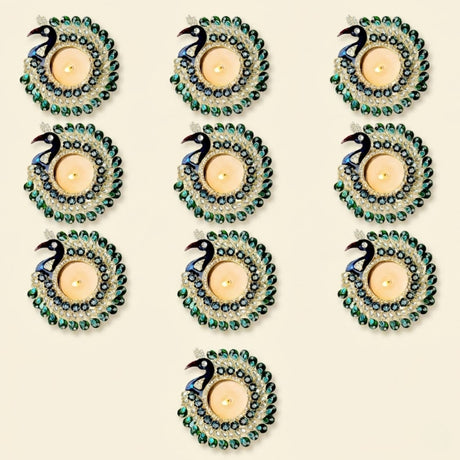 Set of nine ornate peacock tealight candle holders with black and blue heads and crystal-adorned green tails for decor