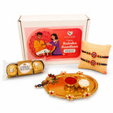 Gold-colored ornate peacock motif tray with two bowls holding red powder and white rice in peacock rakhi gift hamper set