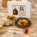 Golden peacock-shaped thali with intricate green and red enamel detailing in peacock rakhi gift hamper set for brother and bhabhi