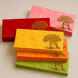 Stacks of vibrant red yellow orange and green paper money envelopes with gold-leaf peacock tree and couple design for weddings and savings
