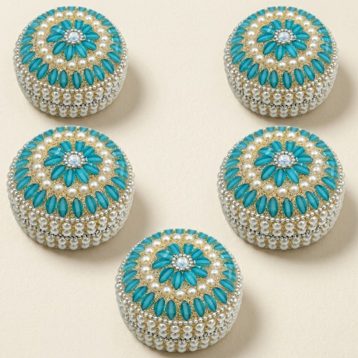 Turquoise and pearl-embellished circular jewelry box with central diamond accent for travel and festivals