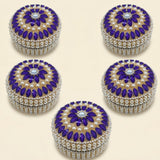 Purple and pearl-embellished circular jewelry box with central blue gemstone for travel and festival gift organizer