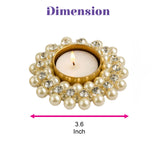 Elegant gold-toned pearl and stone tea light holder decorated with cream pearls and clear rhinestones for festive decor