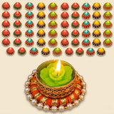 A green rose-shaped candle in an ornate golden pearl candle holder with orange fabric for Diwali and home decor