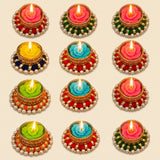 Colorful rangoli Indian diya t-light stand with rose-shaped wax candles in gold metal holders adorned with pearls