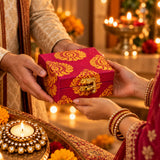 A vibrant magenta handmade gift box with golden paisley patterns for personalized Diwali candle holder gifts