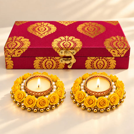 A pair of ornate yellow rose adorned tealight holders with gold accents and pearls for Diwali and home decor gifts