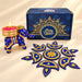 Blue elephant-shaped diya with gold detailing and a lit pink candle for personalize Diwali gifts box and corporate gifting