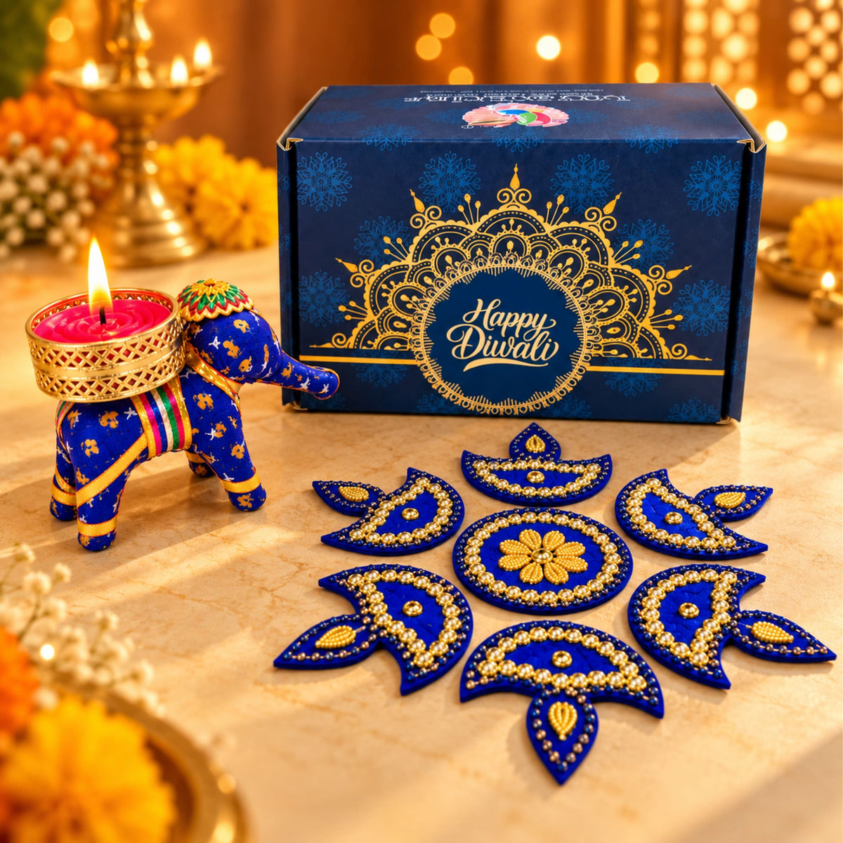 Blue elephant-shaped diya holder with gold accents and lit red candle for personalize Diwali gifts box and corporate gifting