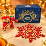 Red elephant-shaped diya holder with gold accents and colorful stripes for Diwali and corporate gifting hampers