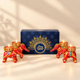 Red and gold elephant-shaped tealight candle holders with intricate patterns from personalized Diwali gifts hamper set