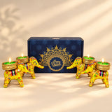 Vibrant yellow elephant-shaped tealight candle holders with floral patterns and gold-trimmed bases for diwali gifts