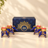 Blue and gold elephant-shaped tealight candle holders with intricate patterns from personalized Diwali gifts hamper set