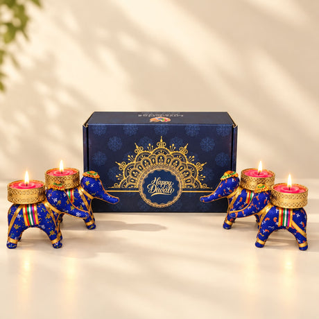 Blue and gold elephant-shaped tealight candle holders with intricate patterns from personalized Diwali gifts hamper set