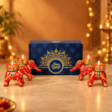 Red elephant-shaped tealight candle holders with gold accents and intricate patterns for diwali gift hamper set