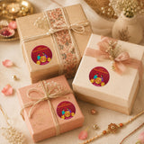 Three elegantly wrapped gift boxes with 24 pcs custom name round stickers for happy Raksha Bandhan on deep red background