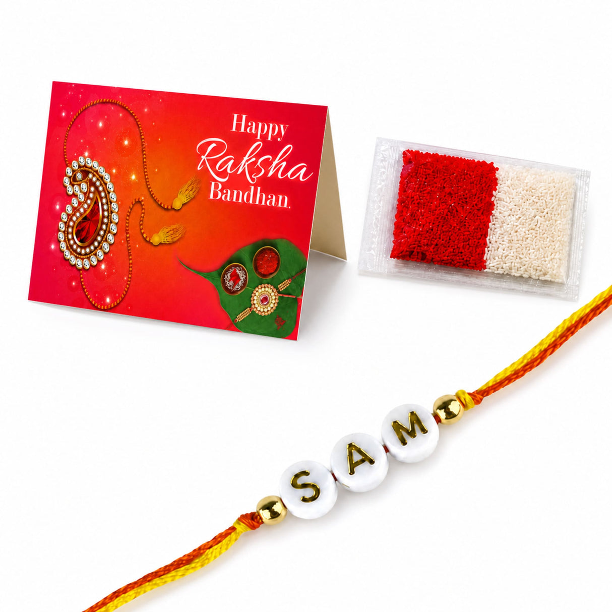 A personalized white bead rakhi with gold lettering and golden beads on vibrant orange and yellow thread for raksha bandhan