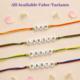 Personalized designer custom named rakhi featuring white letter beads with gold foil on colorful braided cords for protection