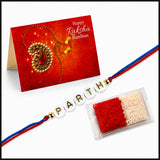 A personalized red and blue thread designer rakhi with white beads spelling parth and gold accents for brother and bhabhi