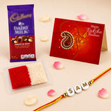 A vibrant red and gold handmade personalized name rakhi with white beads spelling samt for brother and bhabhi gift