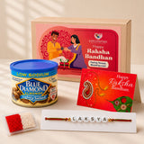 A red and gold raksha bandhan greeting card with paisley design included in a personalized name bead rakhi gift set