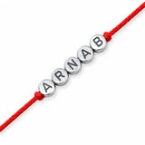 Red cord rakhi bracelet with silver-toned circular beads engraved with name arnab for protection and good luck gift