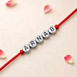 Red cord bracelet with silver beads engraved with the name Arnab for Raksha Bandhan protection and good luck gift
