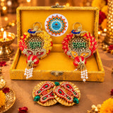 Personalized diwali gifts hamper with golden lacework, red yellow floral accents, jeweled peacock motif, rajasthani brocade design