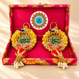 Personalized Diwali gifts hamper with golden ornate paisley patterns red and gold tassels pearls and peacock motifs