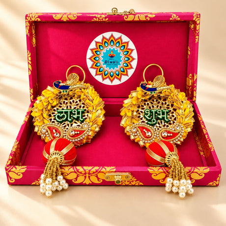 Personalized Diwali gifts hamper with golden ornate paisley patterns red and gold tassels pearls and peacock motifs