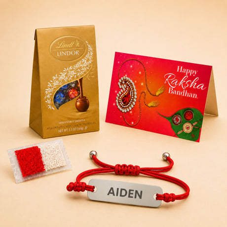 Personalized red braided cord rakhi with a stainless steel silver rectangular tag engraved with name aiden