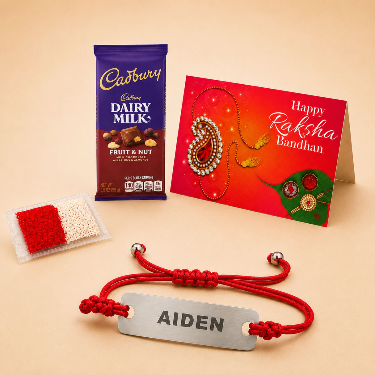 Personalized red braided cord rakhi bracelet with a silver stainless steel plate engraved with the name Aiden for brother