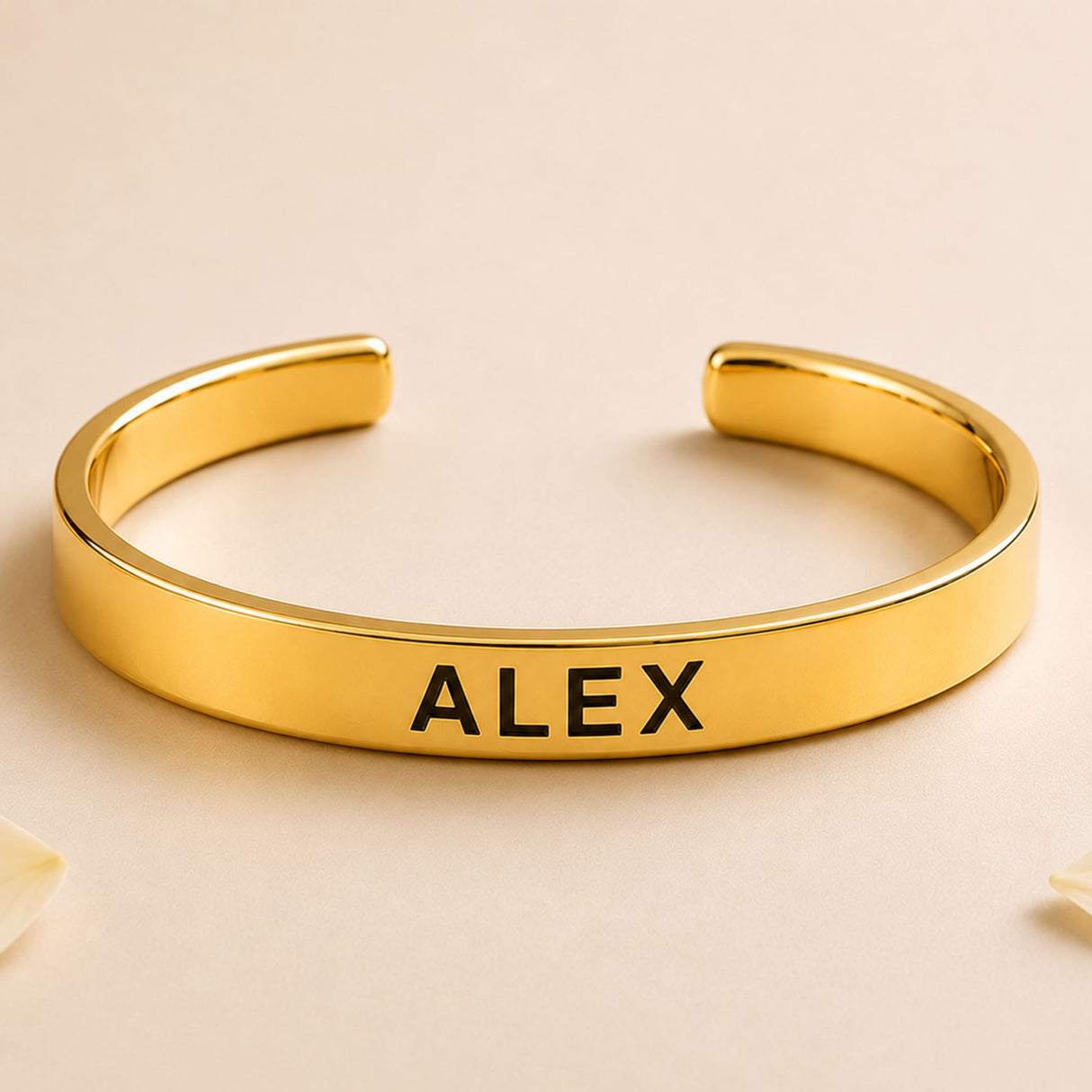 Gold-colored personalized stainless steel cuff bracelet with alex engraved in black for raksha bandhan gift