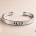 Personalized stainless steel rakhi cuff bracelet in silver with bold black engraved name alex for brother protection gift