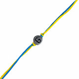 Silver toned circular charm with black engraved letter g on braided yellow and blue cord designer custom rakhi bracelet