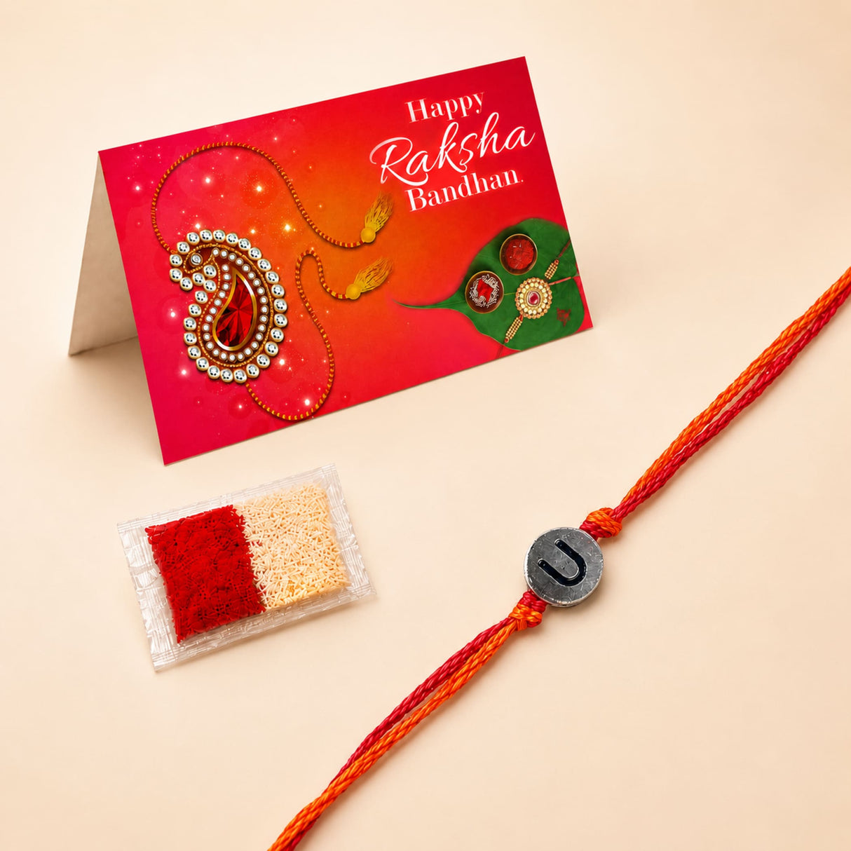 Orange braided rakhi with a silver u-shaped charm designer custom single letter raksha bandhan bracelet for protection and luck