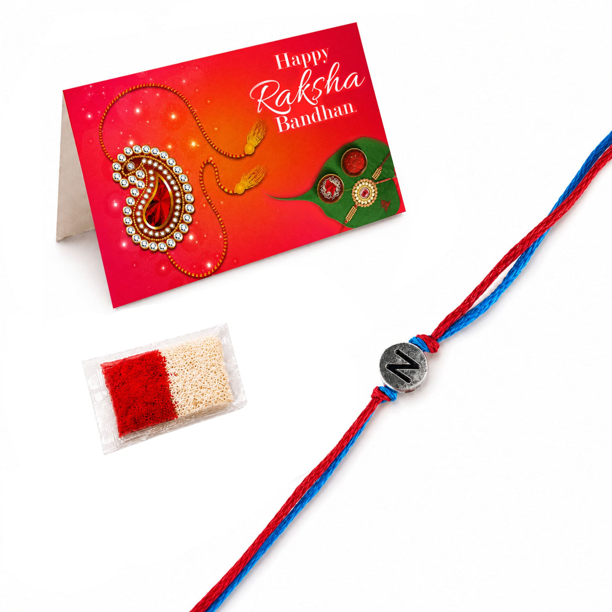 Designer custom single letter rakhi for brother and bhabhi featuring a red and blue braided thread with a silver charm n
