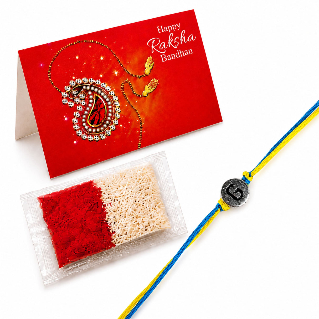 A blue and yellow braided handmade rakhi with a silver circular charm featuring the letter g for brother and bhabhi