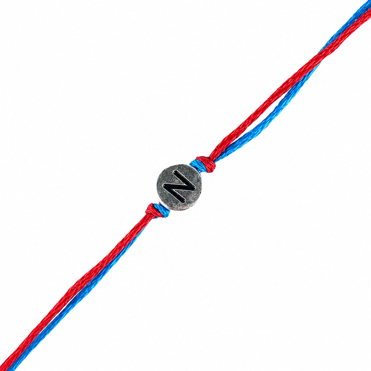 Designer custom single letter rakhi bracelet with red and blue braided cord and silver metal charm engraved with n for protection and good luck