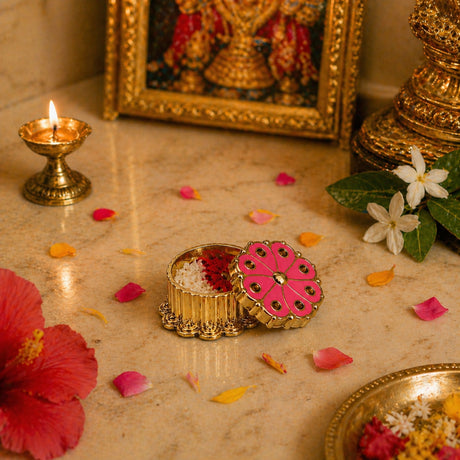 Traditional floral pink haldi kumkum holder with gold floral design and decorative lid featuring circular cutouts
