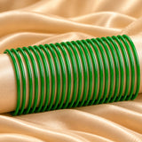 A set of vibrant green 20 ct plain glass bangles with a sleek glossy uniform circular design for women and girls