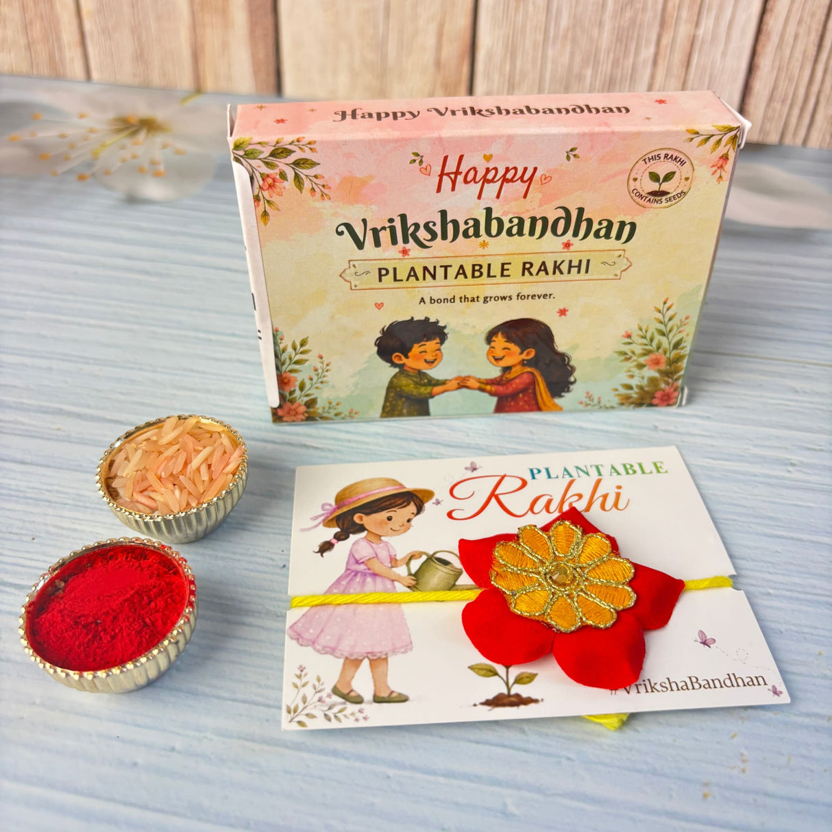 A vibrant red and gold plantable seed rakhi bracelet with yellow ribbon for brother and bhabhi eco-friendly gift