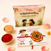 A vibrant circular plantable seed rakhi bracelet with yellow and red mandala fabric for brother and bhabhi gift