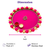 Vibrant pink oval stainless steel pooja thali with gold floral embellishments and pom-poms for rituals and festivals