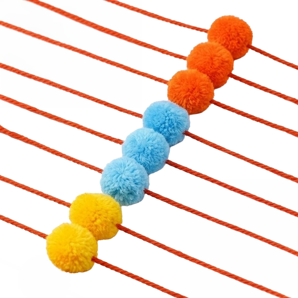 Designer pompom rakhi for god idol featuring vibrant orange blue and yellow fluffy spheres on a red cord