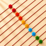 Designer pompom rakhi bracelet with vibrant rainbow-colored fluffy charms on red cord for temple decoration and idols