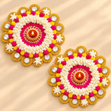 Rangoli mat tealight candle holder featuring vibrant pink white and yellow floral diya decorations with gold accents