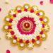 Tea light candle holder rangoli mat with vibrant jasmine flowers pink yellow pom-poms gold foil and central diya for festive decor