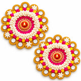 Rangoli mat tealight candle holder with vibrant pink and yellow floral designs, artificial flowers, and metallic accents