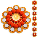 Ornate orange and gold floral Rangoli mat tealight candle holder with mirrored petals and fluffy pom-poms for festive decor